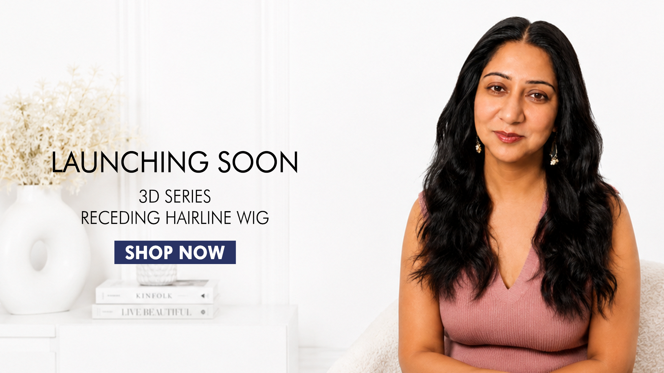 Woman with long black hair sitting on a white couch, promotional text for a wig launch.